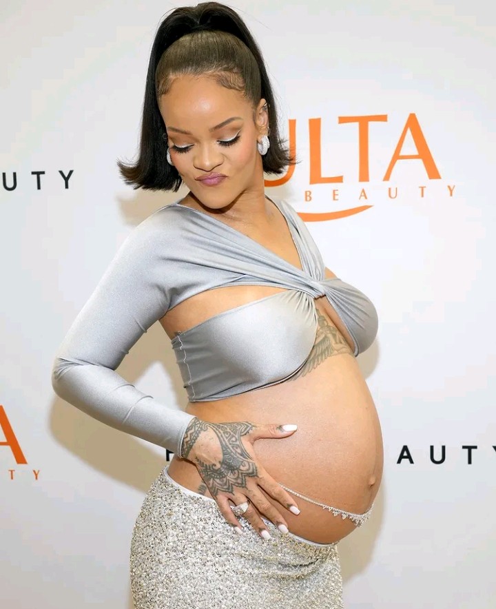 Mom-to-be Rihanna bares baby bump in silver crop top at Fenty Beauty party