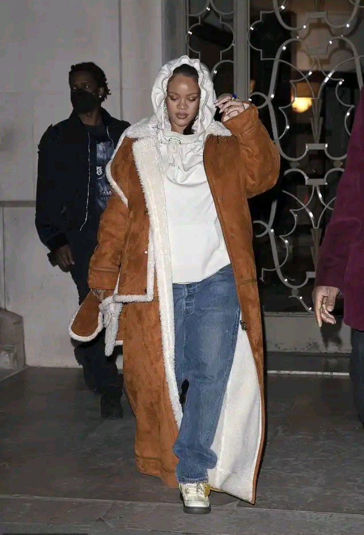 Pregnant Rihanna covers up her growing baby bump in a shearling overcoat and sweatshirt 