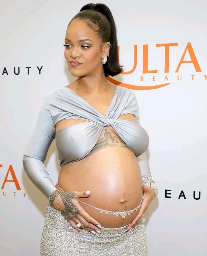 Mom-to-be Rihanna bares baby bump in silver crop top at Fenty Beauty party