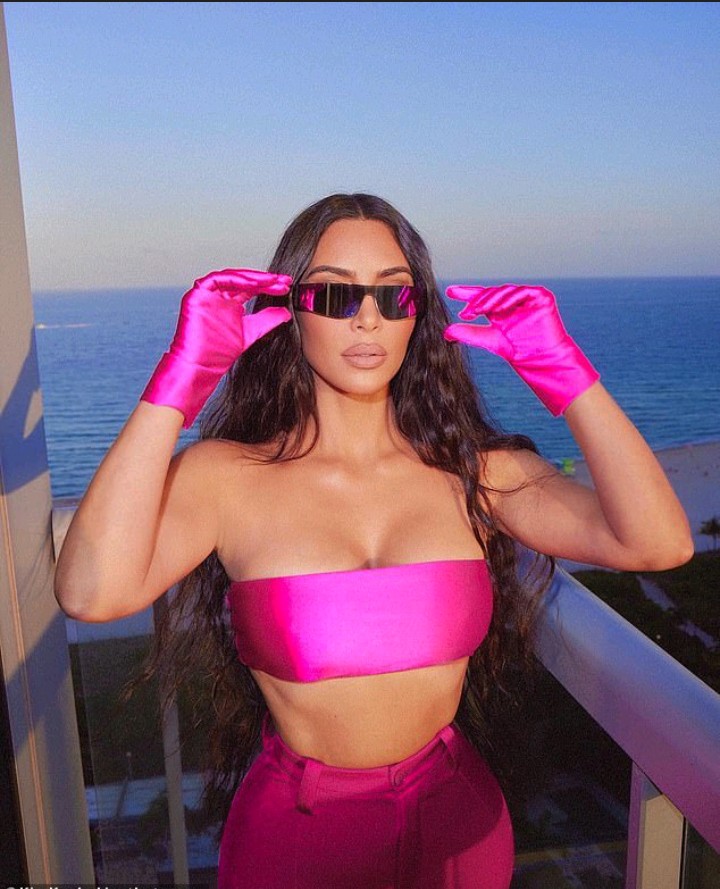 Kim is hot in pink as she poses up a storm in SKIMS bandeau and trousers on  ocean-front balcony