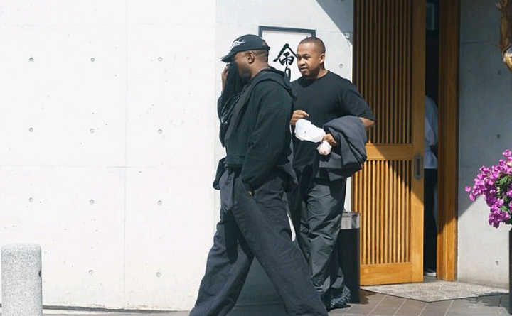 Kanye West emerges leaving sushi restaurant as he continues month-long sabbatical in Japan