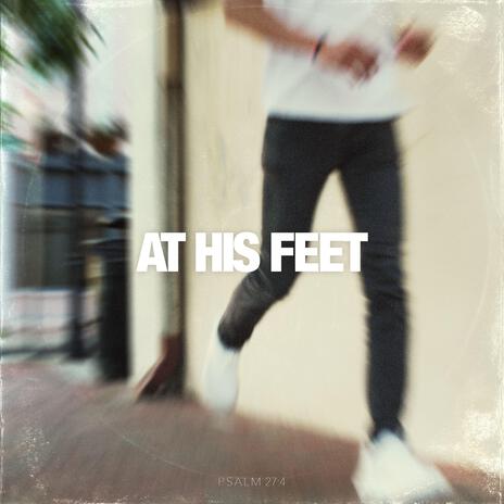 AT HIS FEET